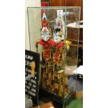 A pair of Indonesian carved and painted wood puppets in glazed display case, overall height 29".