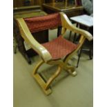 An oak X framed chair with upholstered seat by Holland of Rye.