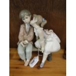A Lladro group 7635, "10 And Growing," young girl kissing a boy on a bench.