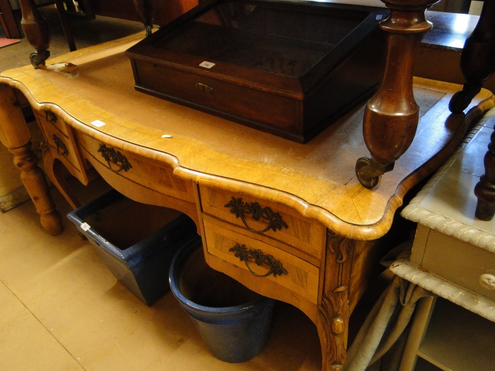 A walnut serpentine front kneehole writing desk,
