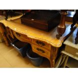 A walnut serpentine front kneehole writing desk,