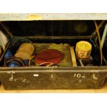 A military tin trunk containing a collection of uniforms, 1949 Para beret and others, leather belts,