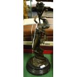 A reproduction bronze candle holder supported by a dancing girl, height 13".