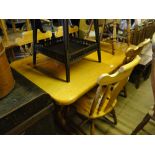 A rectangular pine kitchen table, together with 6 matching pine chairs.