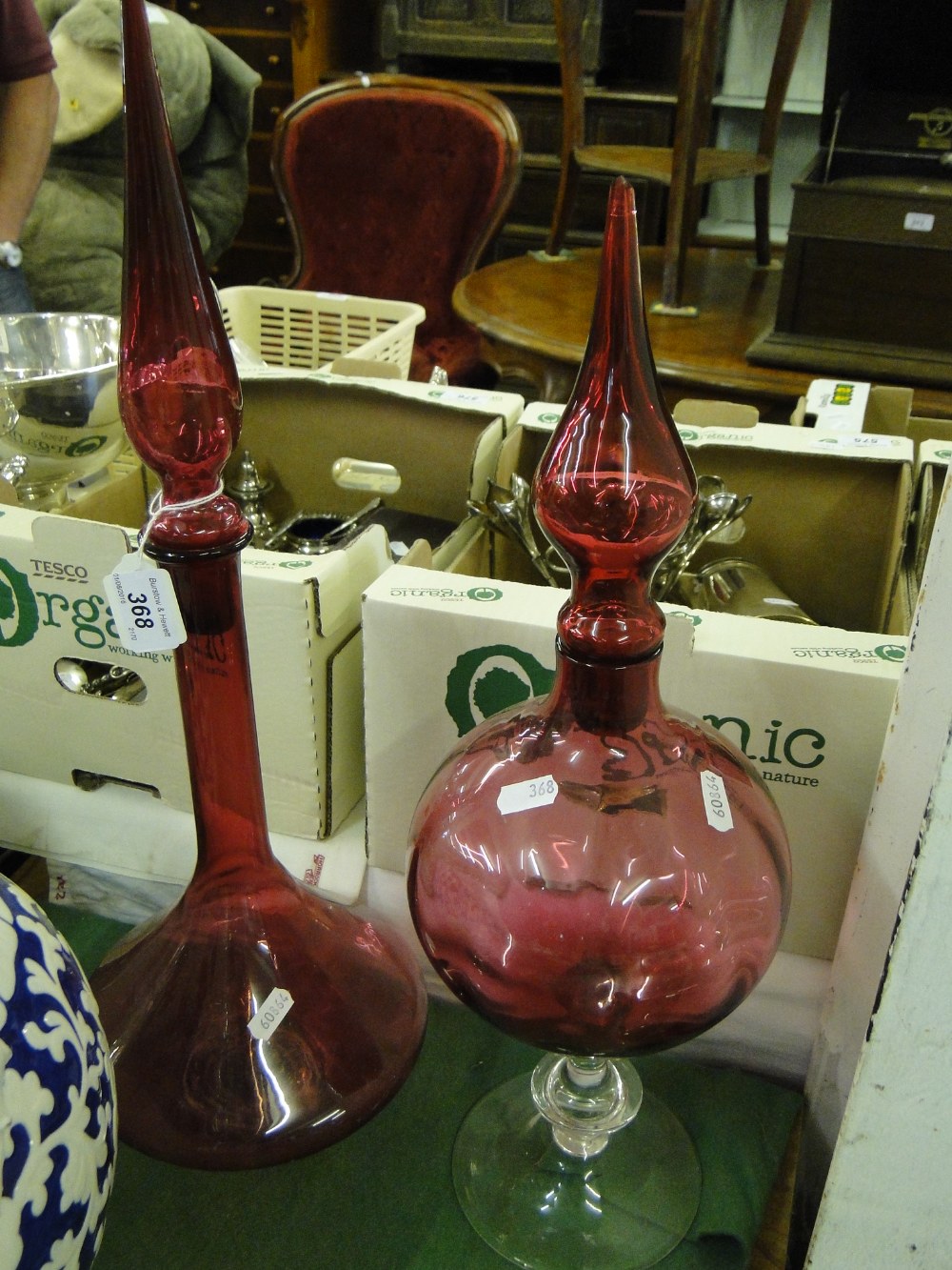A cranberry glass chemist's bottle and stopper and another, (2).
