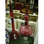 A cranberry glass chemist's bottle and stopper and another, (2).