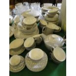 An extensive Poole 2-tone dinner service and teaset comprising 2 tureens, dinner plates and teapot.