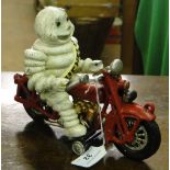 A Michelin Man (Bibendum) cast iron figure on motorbike