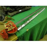 A reproduction sword in scabbard with brass hilt
