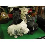 A pair of cast metal terriers and a black and white whisky bar figure