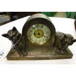 A small clock with cat figure mounts "Two Scamps.
