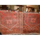 Pair of red ground Persian rugs