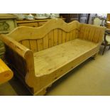 A large and polished pine settle with shaped back, length 6'8".