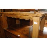 A modern pine rectangular coffee table with carved decoration.