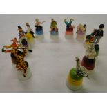 A Collection of painted thimbles surmounted by figures.