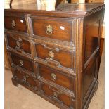 A 1920s joined oak chest, fitted with 4 filing drawers raised on bracket feet.