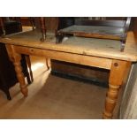 A rectangular pine kitchen table with baluster turned legs.