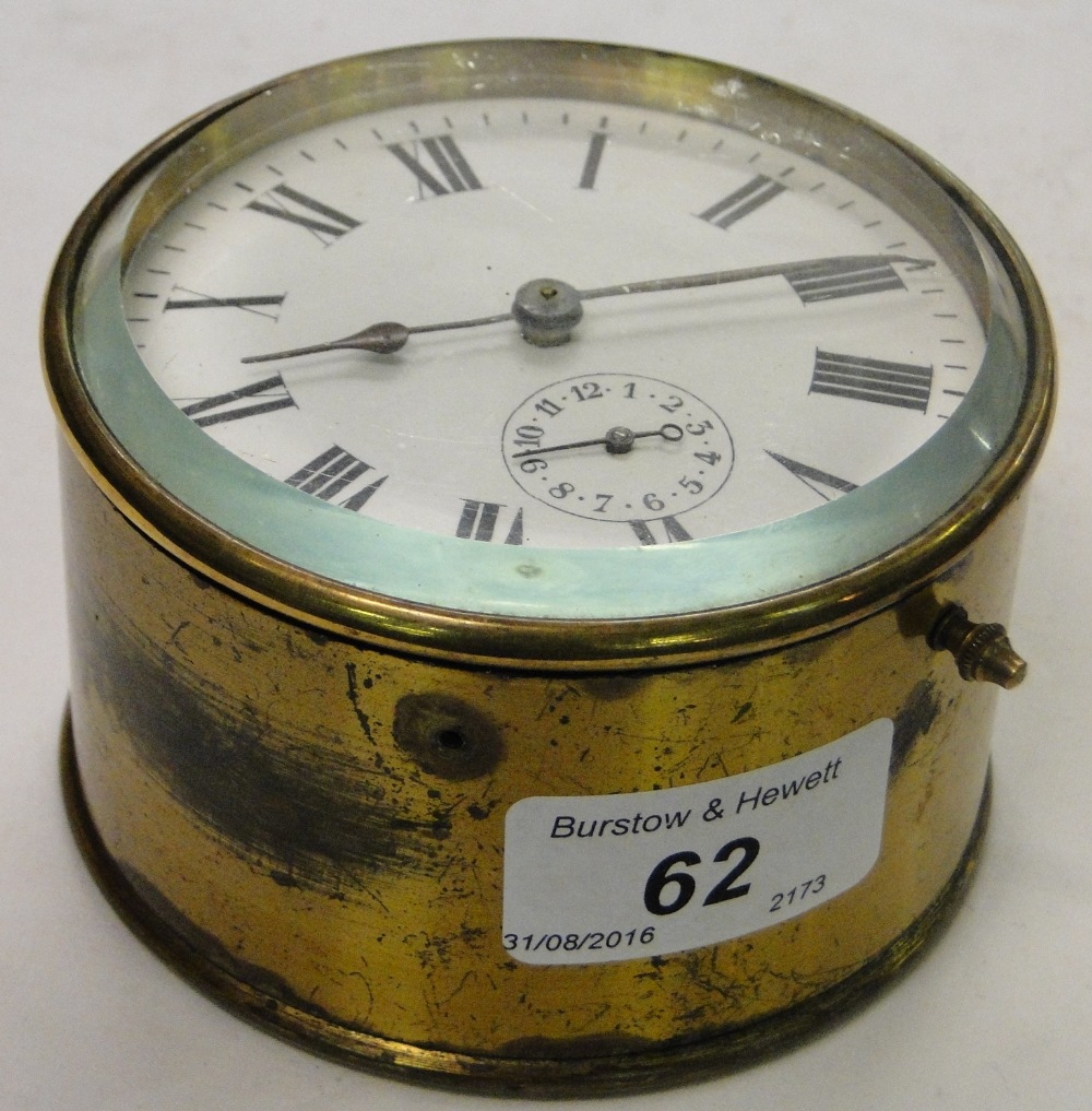 Circular brass cased small clock.