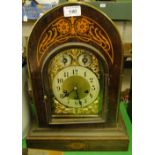 A mahogany domed top mantel clock with 3-train movement.