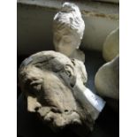 A painted plaster bust and a concrete head.