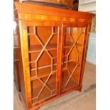 A reproduction yewwood 2-door bookcase.