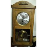 An oak cased kitchen wall clock.