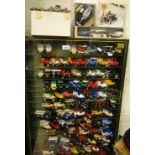 A display case with a large collection of die-cast cars, etc.