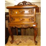 A Carved hardwood bedside chest with 2 drawers