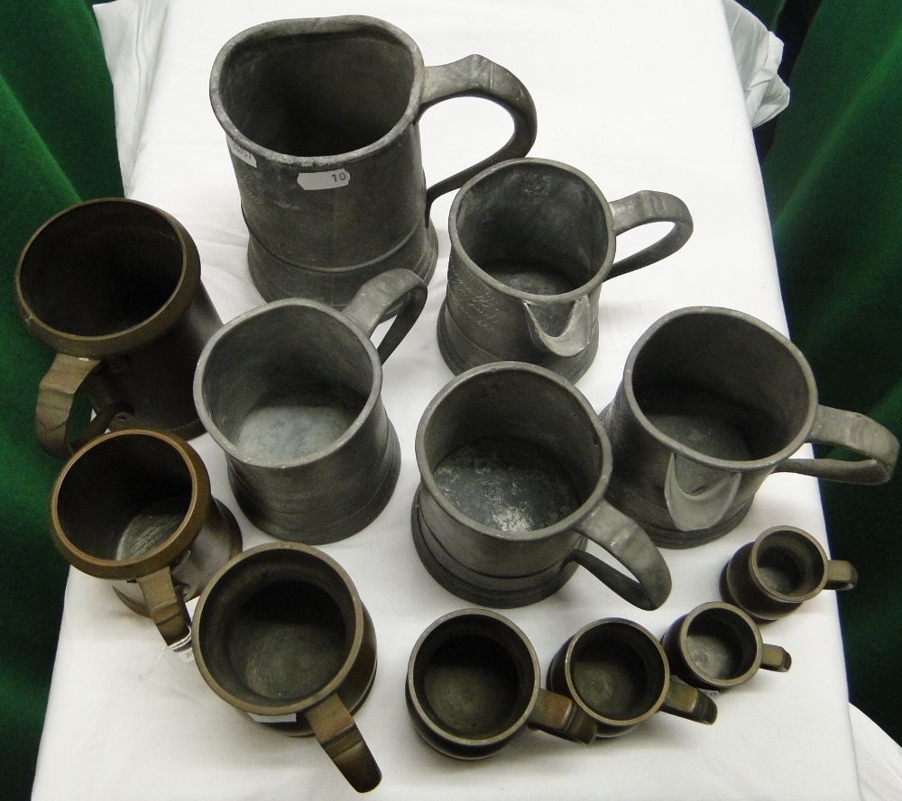 Various 19th century pewter measures and side pouring jugs, and Victorian brass measures.