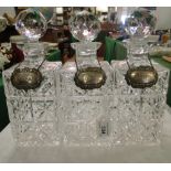 A set of 3 decanters with silver decanter labels.