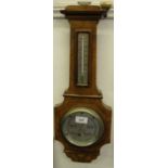 A walnut cased aneroid barometer.