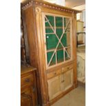 An Antique continental pine cabinet, with glazed and panelled doors.