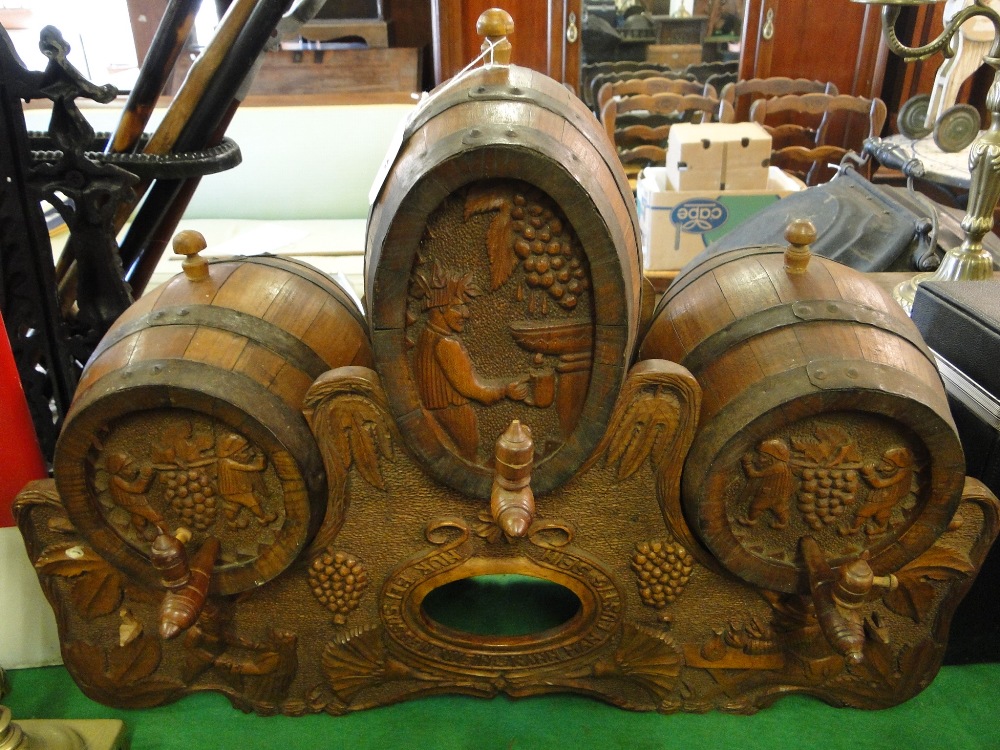 A continental carved bar stand with barrels and taps.