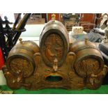 A continental carved bar stand with barrels and taps.