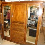 Victorian mahogany compactum wardrobe, having a centre fitted cupboard flanked by mirror doors,