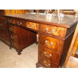 A mahogany twin pedestal writing desk, with a leather skiver and 9 short drawers.