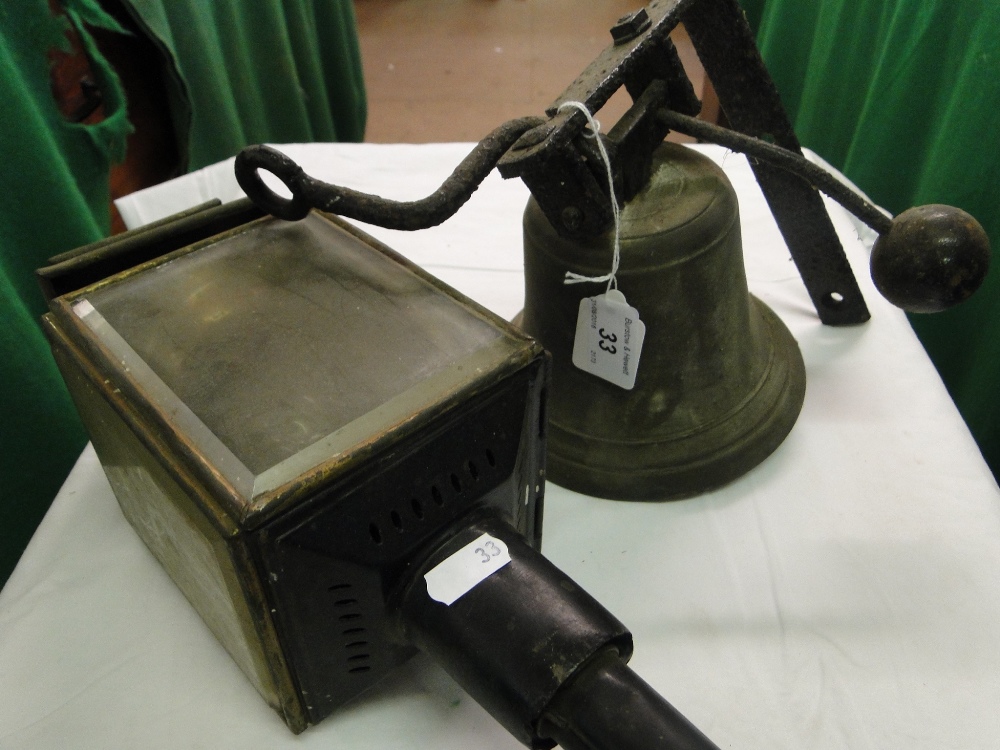 A carriage lamp and a bell with iron mounting bracket.