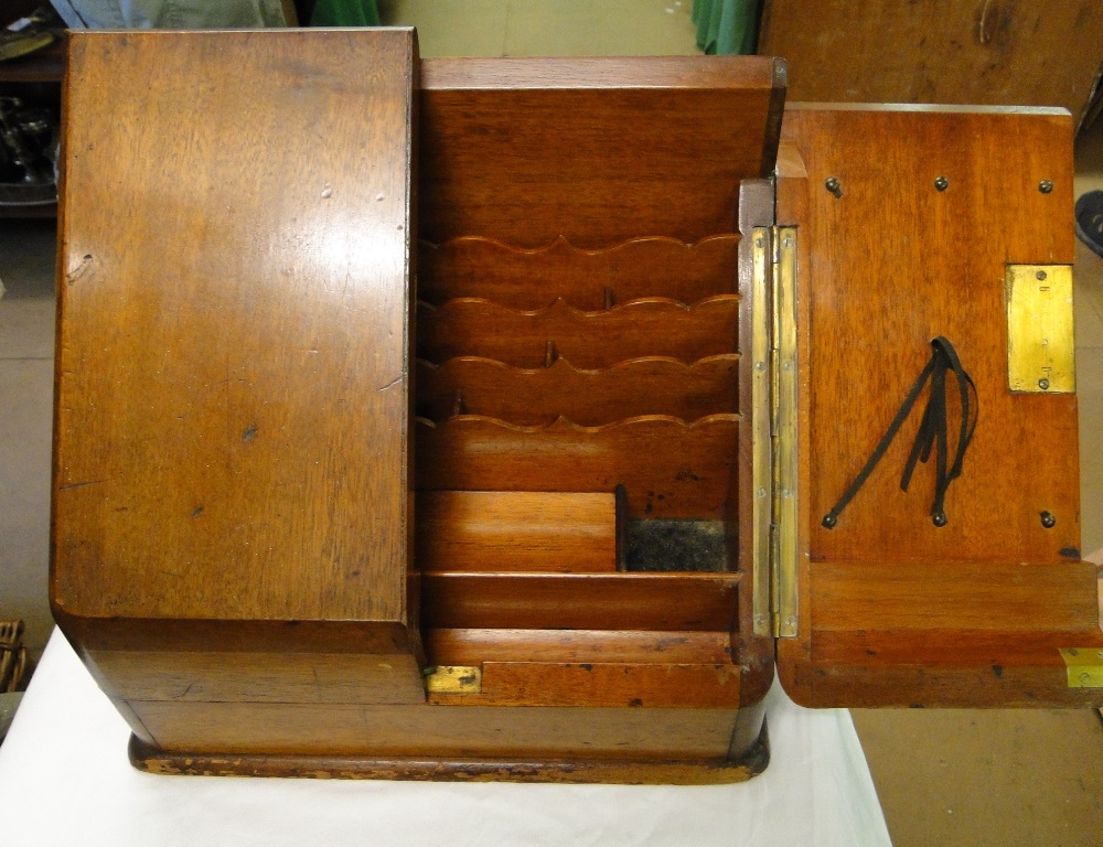 A mahogany table top stationery cabinet.