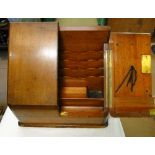 A mahogany table top stationery cabinet.