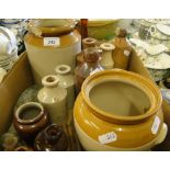 A box of stoneware bottles and jars.