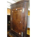 A Georgian oak hanging corner cupboard with single panelled door and marquetry inlay decoration.