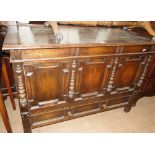 A carved and panelled oak mule chest.