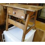 A Vintage pine side table with single frieze drawer on splayed legs.