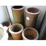 Pair of tall terracotta chimney pots and 3 small terracotta pots.