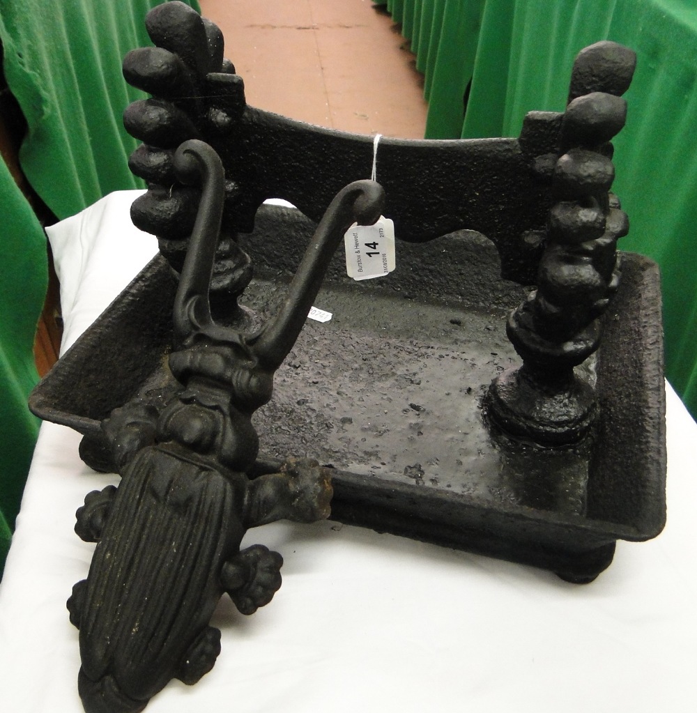 A cast-iron boot scraper and a beetle design boot jack.