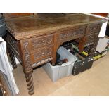 A carved and panelled oak writing desk,