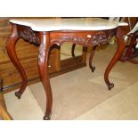 A Carved mahogany serpentine front consol table with shaped grey veined marble top