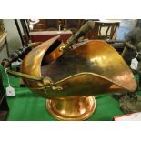 A Victorian copper coal scuttle with matching shovel.