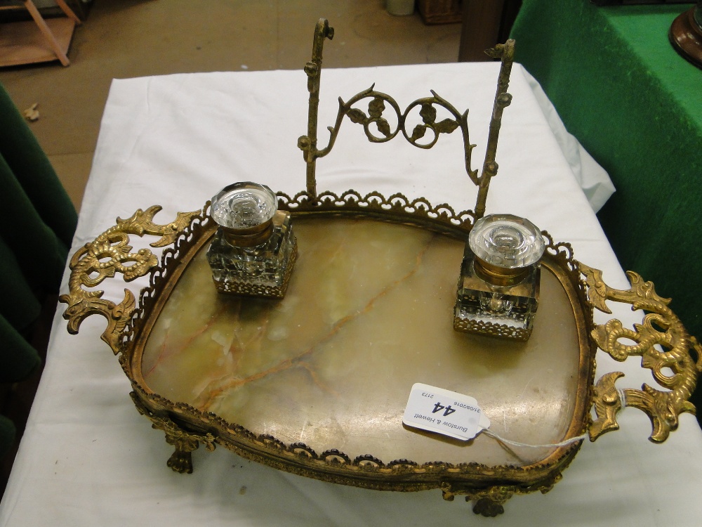 An ormolu and onyx desk stand with fitted cut-glass inkwells.