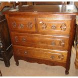 A French carved oak chest, of 2 short and 2 long drawers.